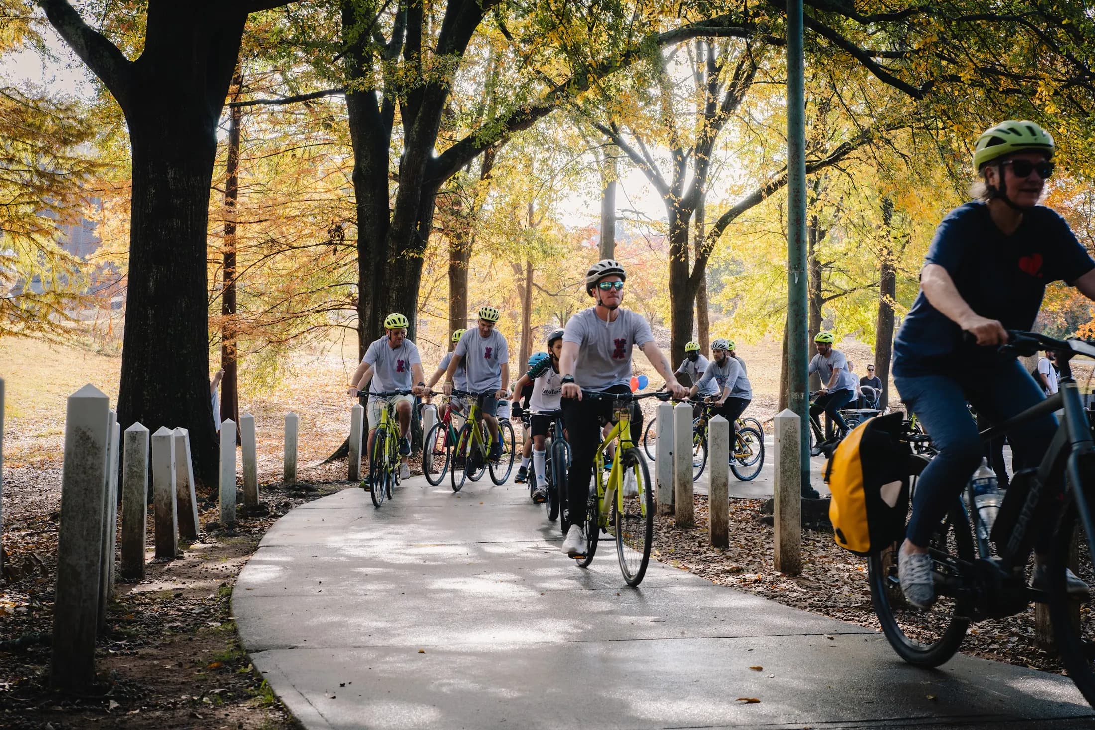 Cyclists ride along a tree-lined path at the 2025 Pedal for P-Man.